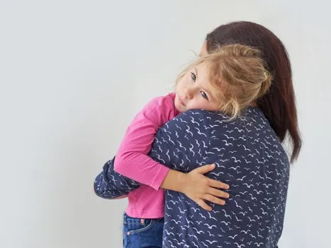 A parent hugging a child