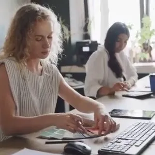 Two colleagues talking at a desk